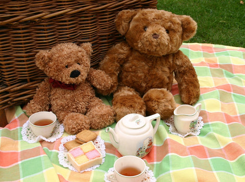 Teddy Bear Picnic on the Farm (price for 2 adults 1 child) features cuddly bears enjoying tea and treats in a cozy setting.