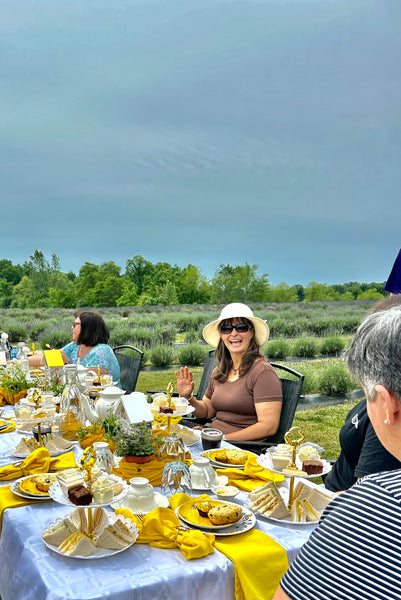 Outdoor dining at a long table in a lavender field for Immersive Honey Bee Experience, Haldimand County, Ontario.