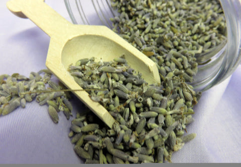 Lavender Buds non culinary, fragrant lavender buds spilling from a jar with a wooden scoop.